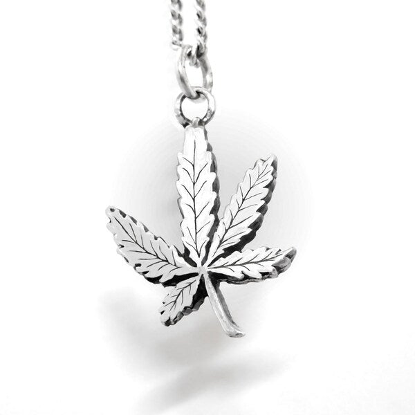 Silver cannabis leaf pendant on a chain against a white background