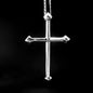 Silver cross pendant on a black background