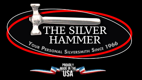 Logo of 'The Silver Hammer' with a silver hammer and text on a black background