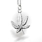 Silver cannabis leaf pendant on a chain against a white background